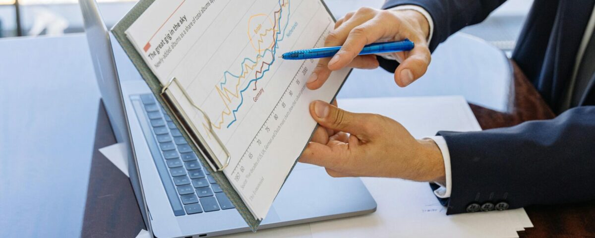 Free Business professionals discussing financial graphs and charts in an office setting. Stock Photo
