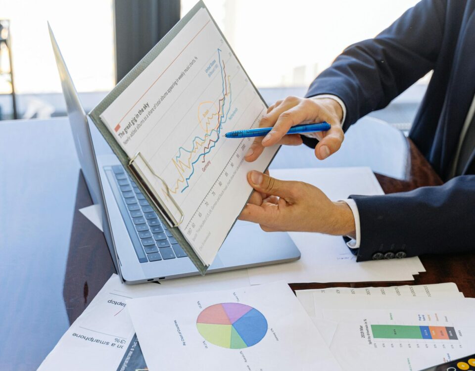 Free Business professionals discussing financial graphs and charts in an office setting. Stock Photo