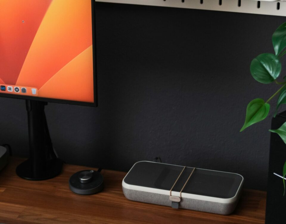 a desk with a laptop, keyboard, mouse and a monitor