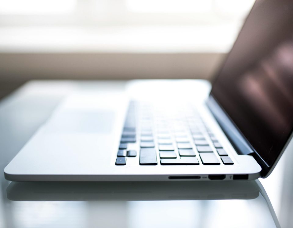 Free Elegant side view of a laptop on a glossy table with natural lighting indoors. Stock Photo