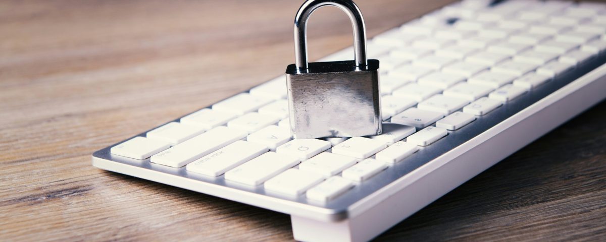 a computer keyboard with a padlock on top of it