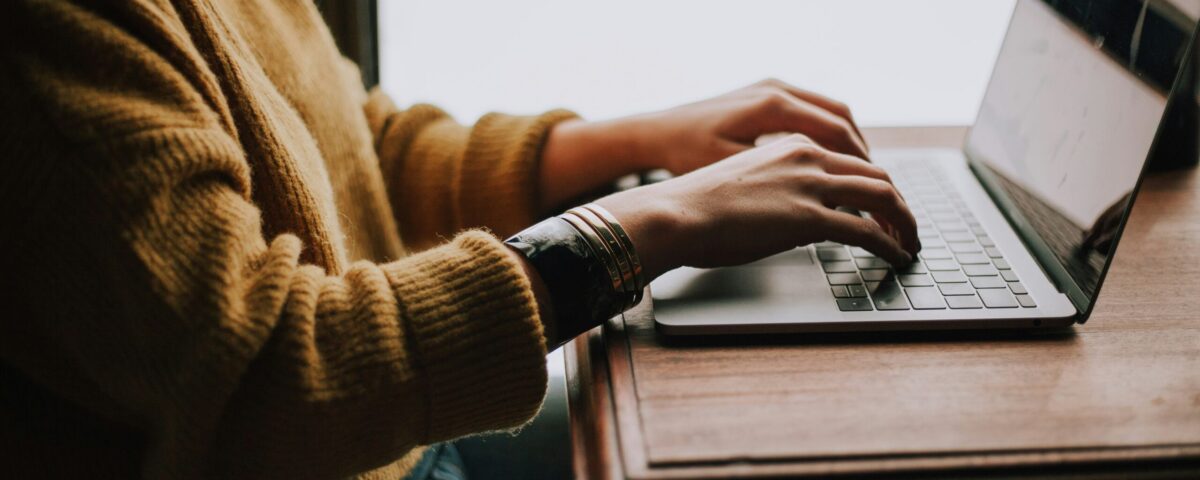person sitting front of laptop